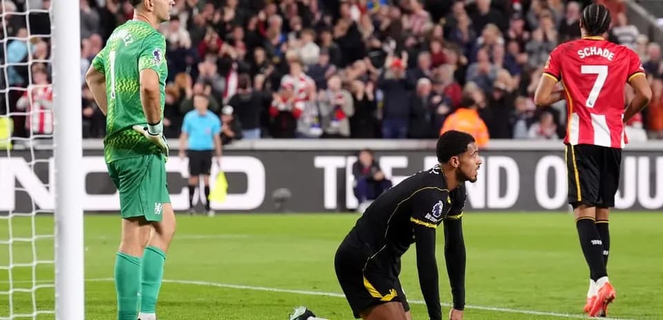 Goalkeeper and defender react after conceding a goal