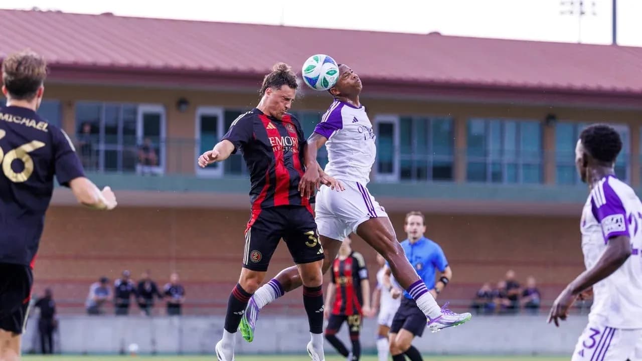 Players contesting a header during match
