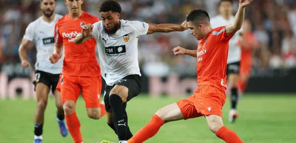 Real Sociedad player challenging Valencia player