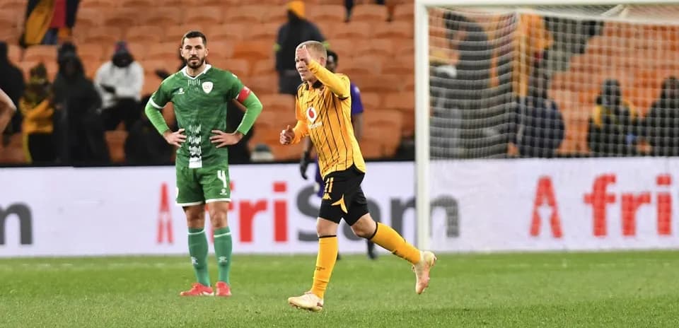 Player celebrating while opponent looks on in stadium