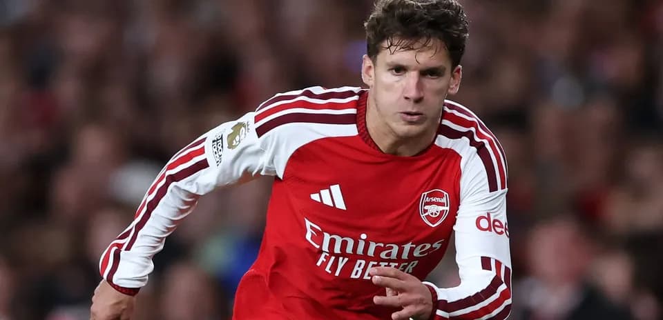 Player sprinting in Arsenal home kit during match Player sprinting in Arsenal home kit during match