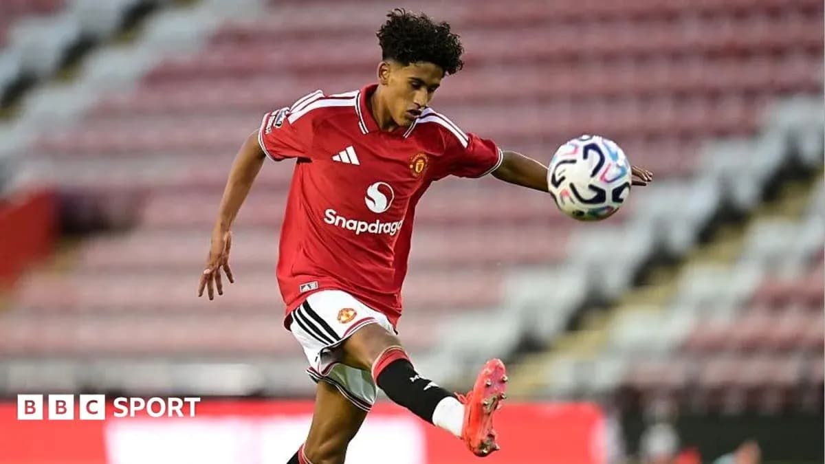 Player kicking a football during a match Player kicking a football during a match