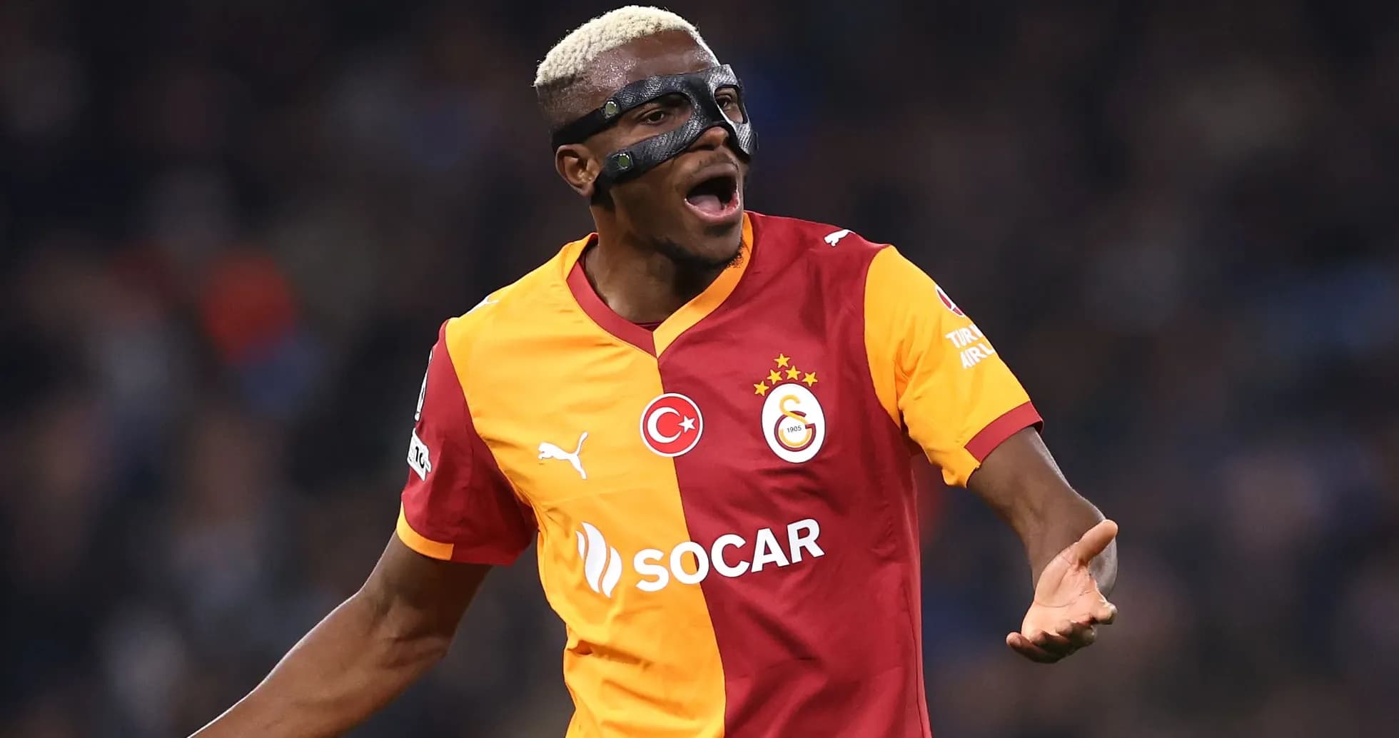 Player in mask celebrating during a match Player in mask celebrating during a match