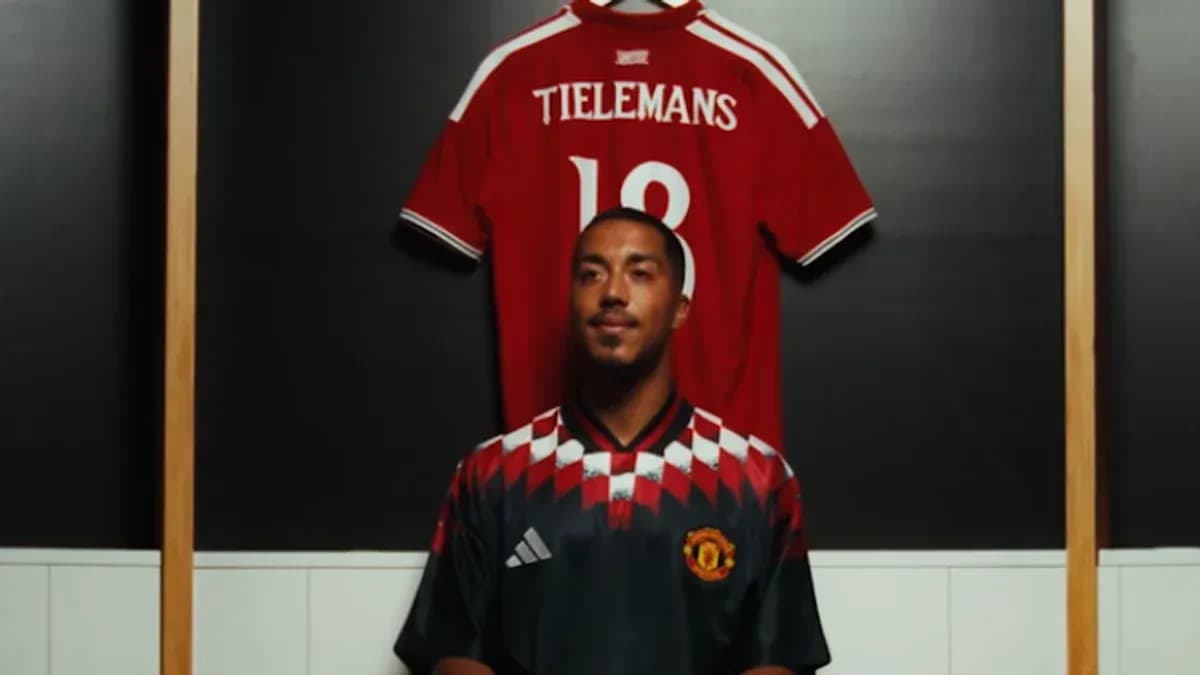 Player posing in front of team jerseys Player posing in front of team jerseys