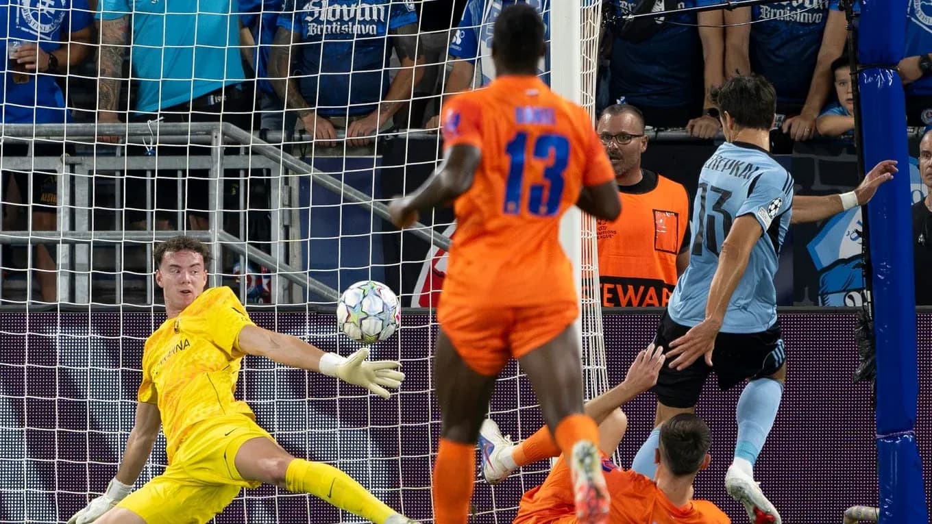 Goalkeeper saving a shot during UEFA match Goalkeeper saving a shot during UEFA match