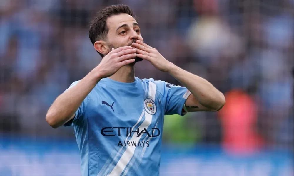Player celebrating with hands to face on pitch Player celebrating with hands to face on pitch