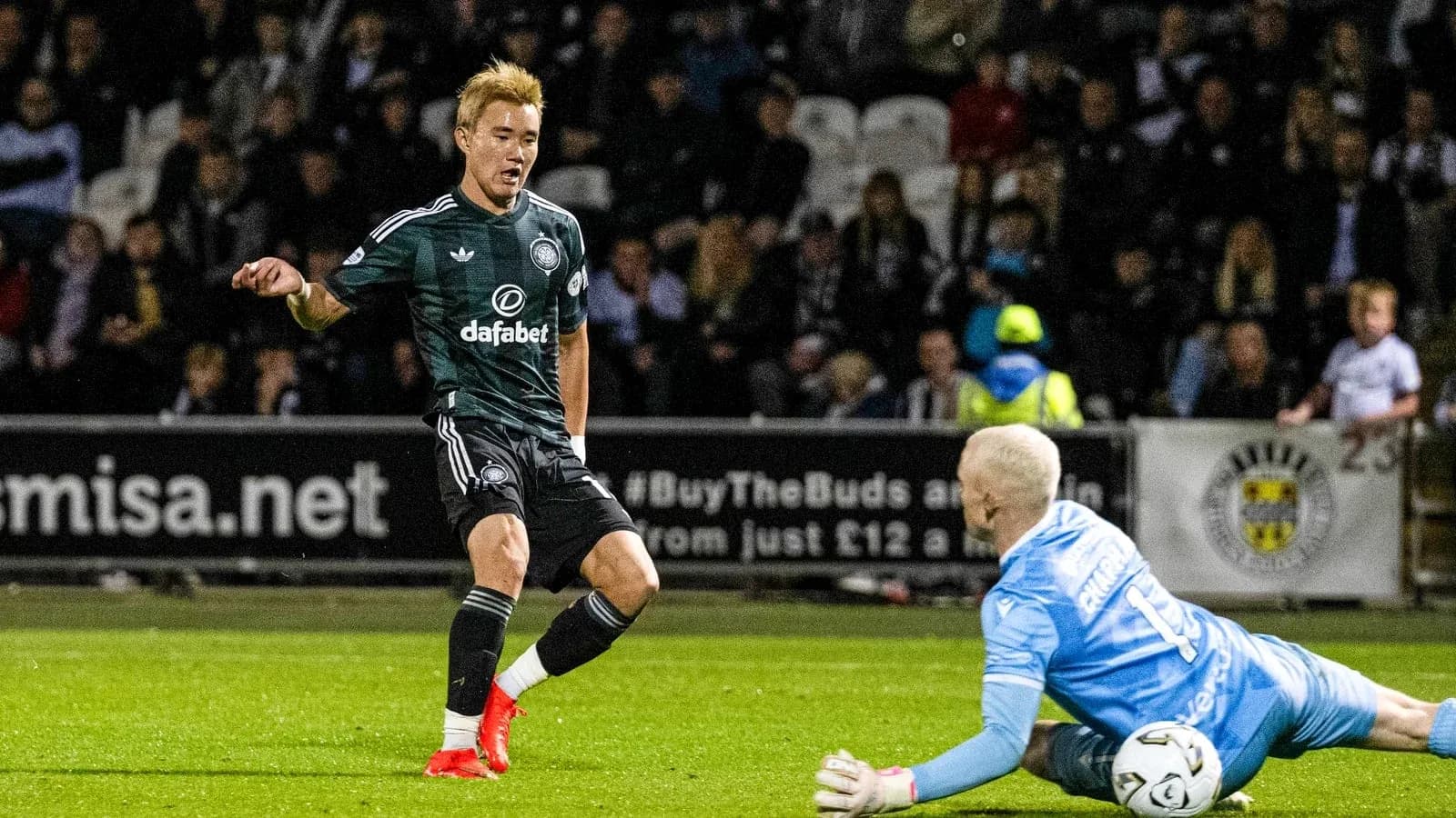 Player evading goalkeeper during a football match Player evading goalkeeper during a football match