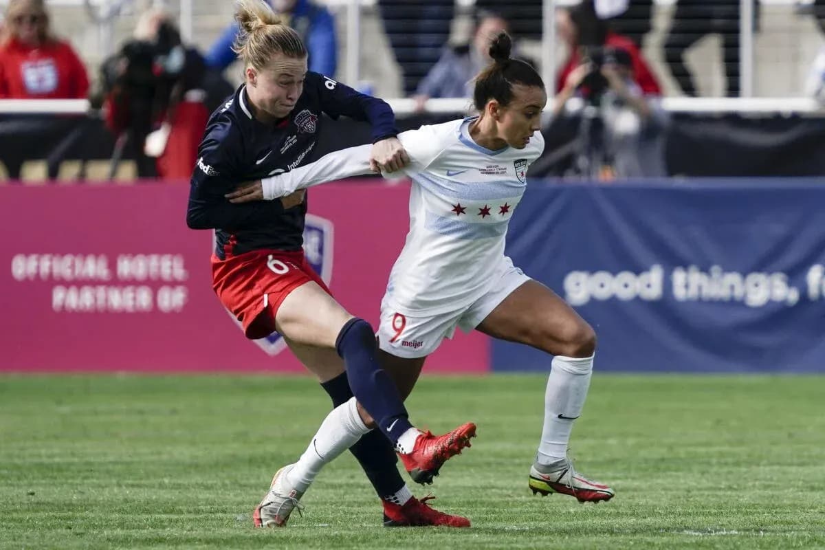 Players contesting the ball during NWSL match Players contesting the ball during NWSL match