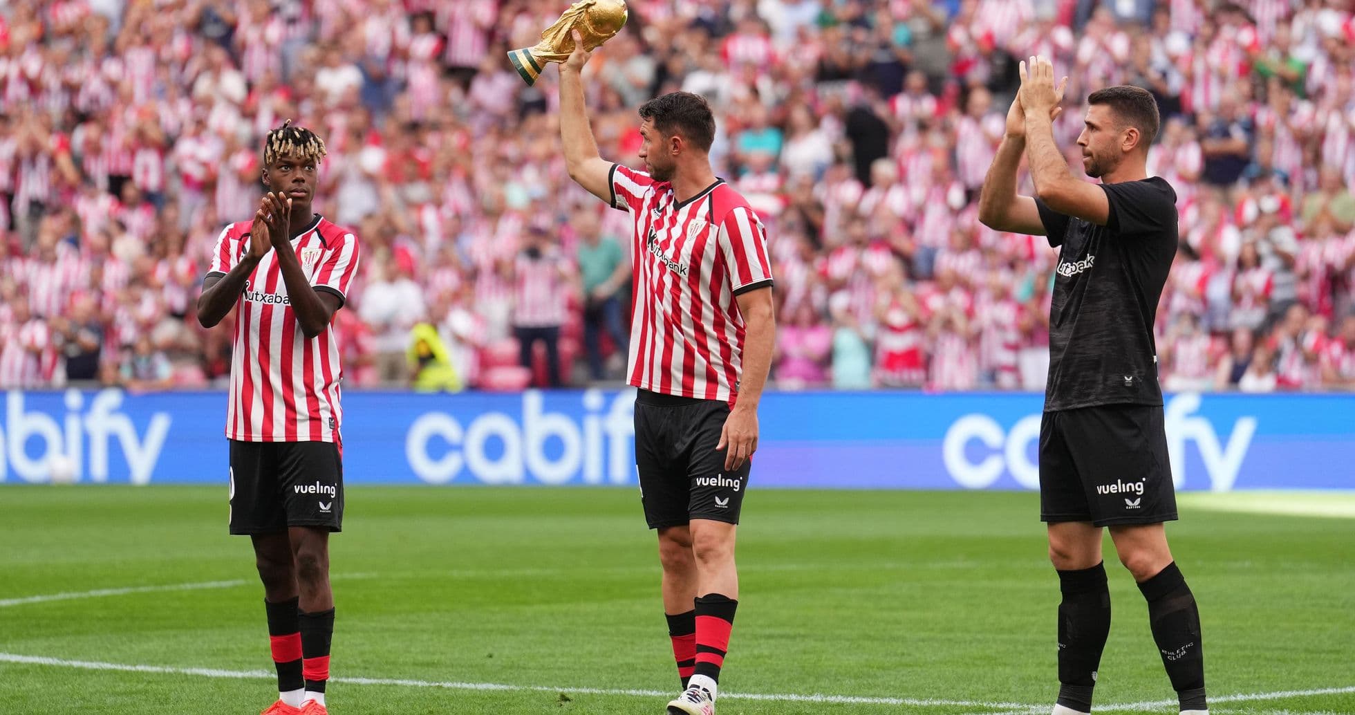 Athletic Bilbao players celebrating with trophy at stadium Athletic Bilbao players celebrating with trophy at stadium