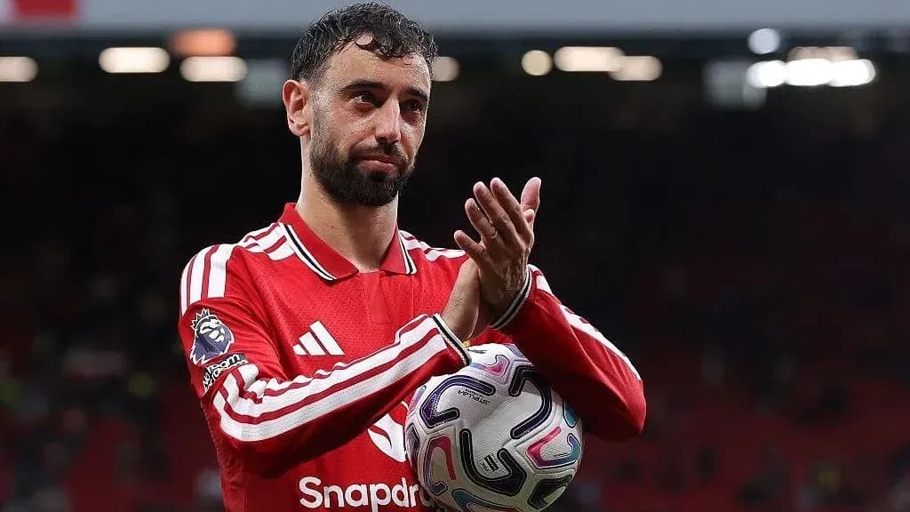 Player applauding while holding a football Player applauding while holding a football