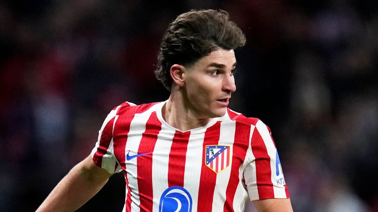 Atletico Madrid player running during a match Atletico Madrid player running during a match