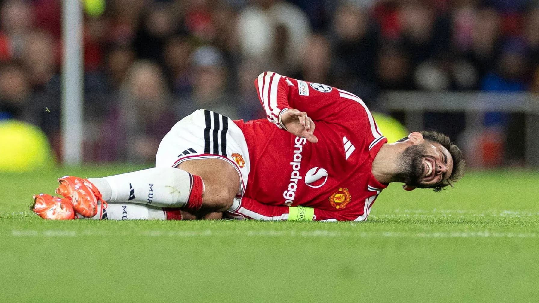 Player lying on pitch after sustaining injury Player lying on pitch after sustaining injury