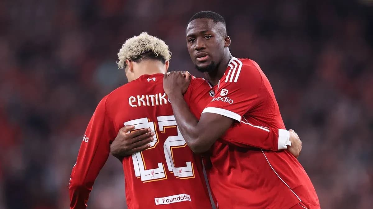 Two players embracing on the pitch during match Two players embracing on the pitch during match