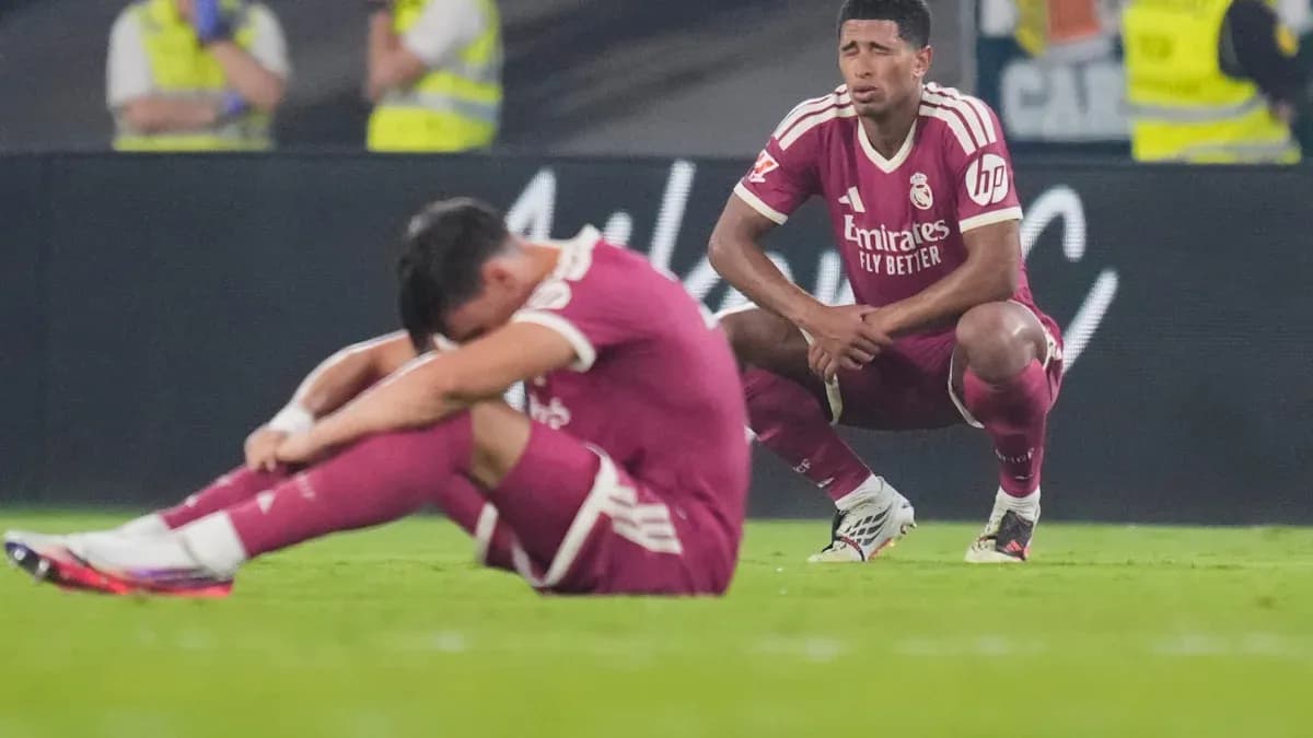 Real Madrid players sitting on the field after match Real Madrid players sitting on the field after match