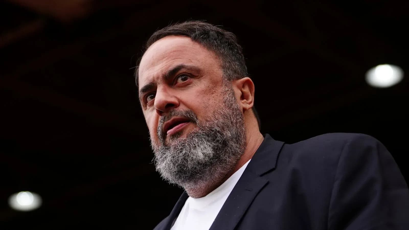 Man speaking at an outdoor event or press conference Man speaking at an outdoor event or press conference