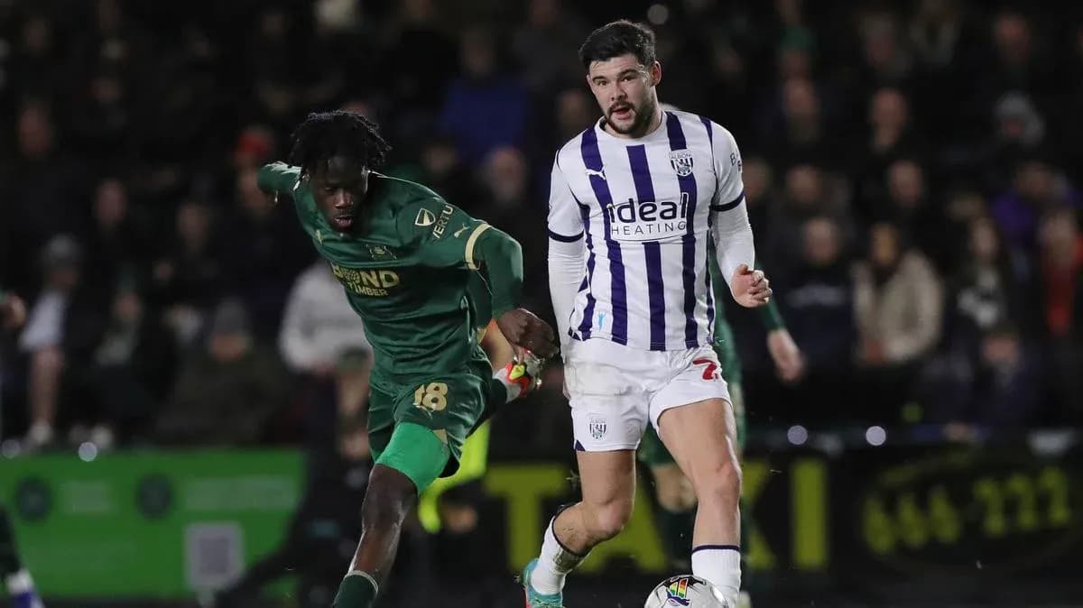 Two players competing for the ball in a match Two players competing for the ball in a match