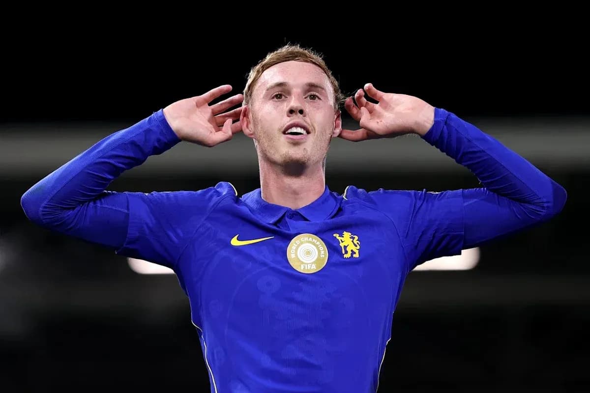 Player celebrating with hands to ears in blue kit Player celebrating with hands to ears in blue kit