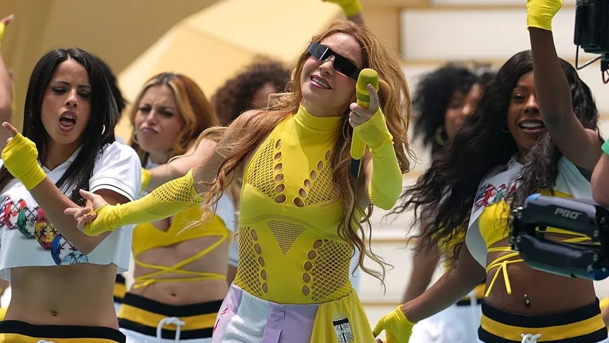 Performer dancing with backup dancers in bright outfits Performer dancing with backup dancers in bright outfits