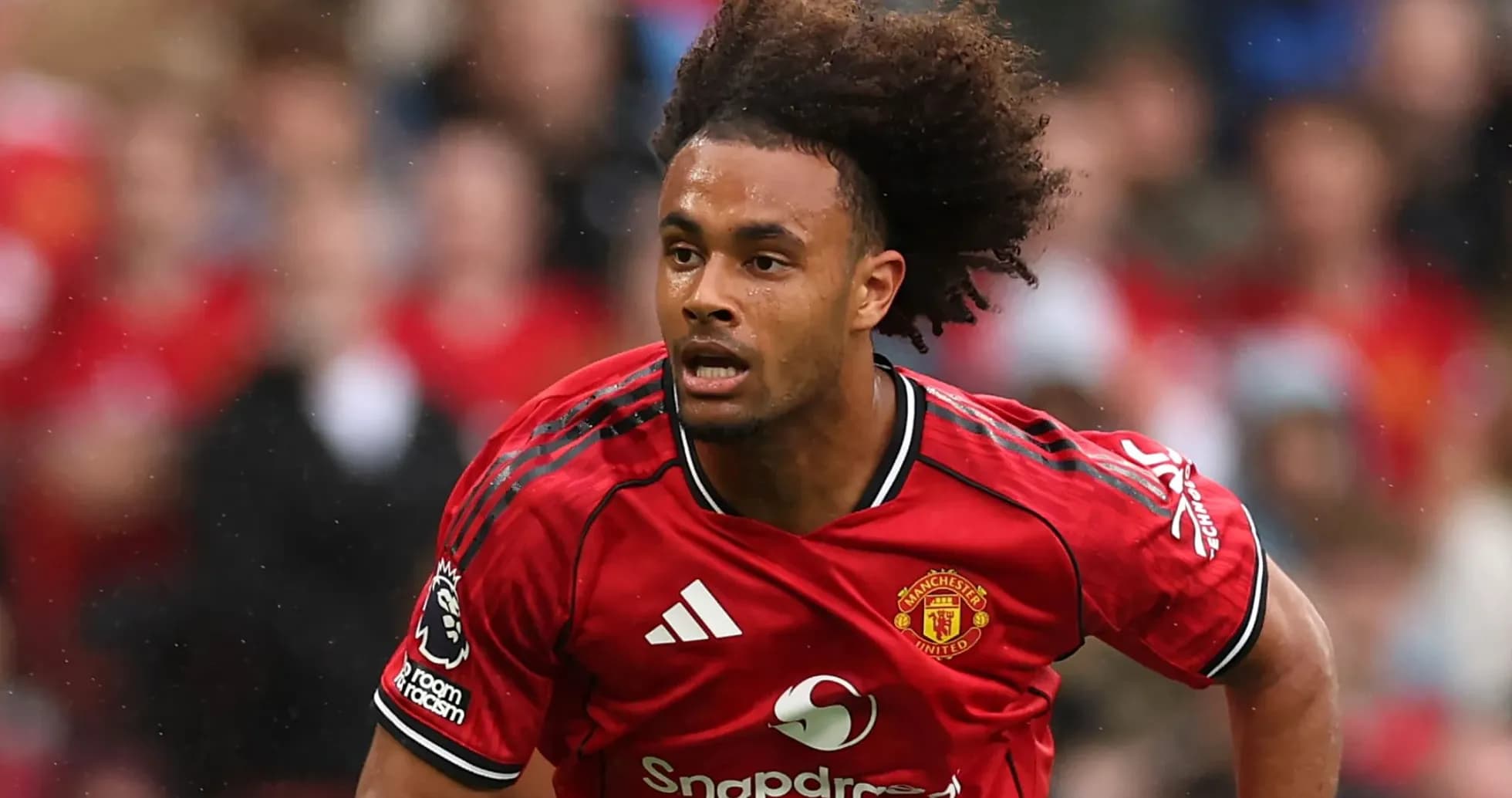 Player in Manchester United kit running on field Player in Manchester United kit running on field
