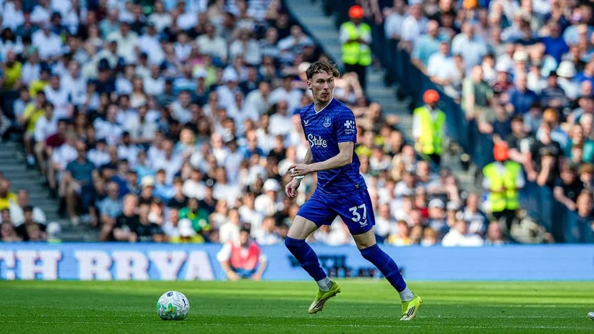Player in blue jersey running with ball during match Player in blue jersey running with ball during match