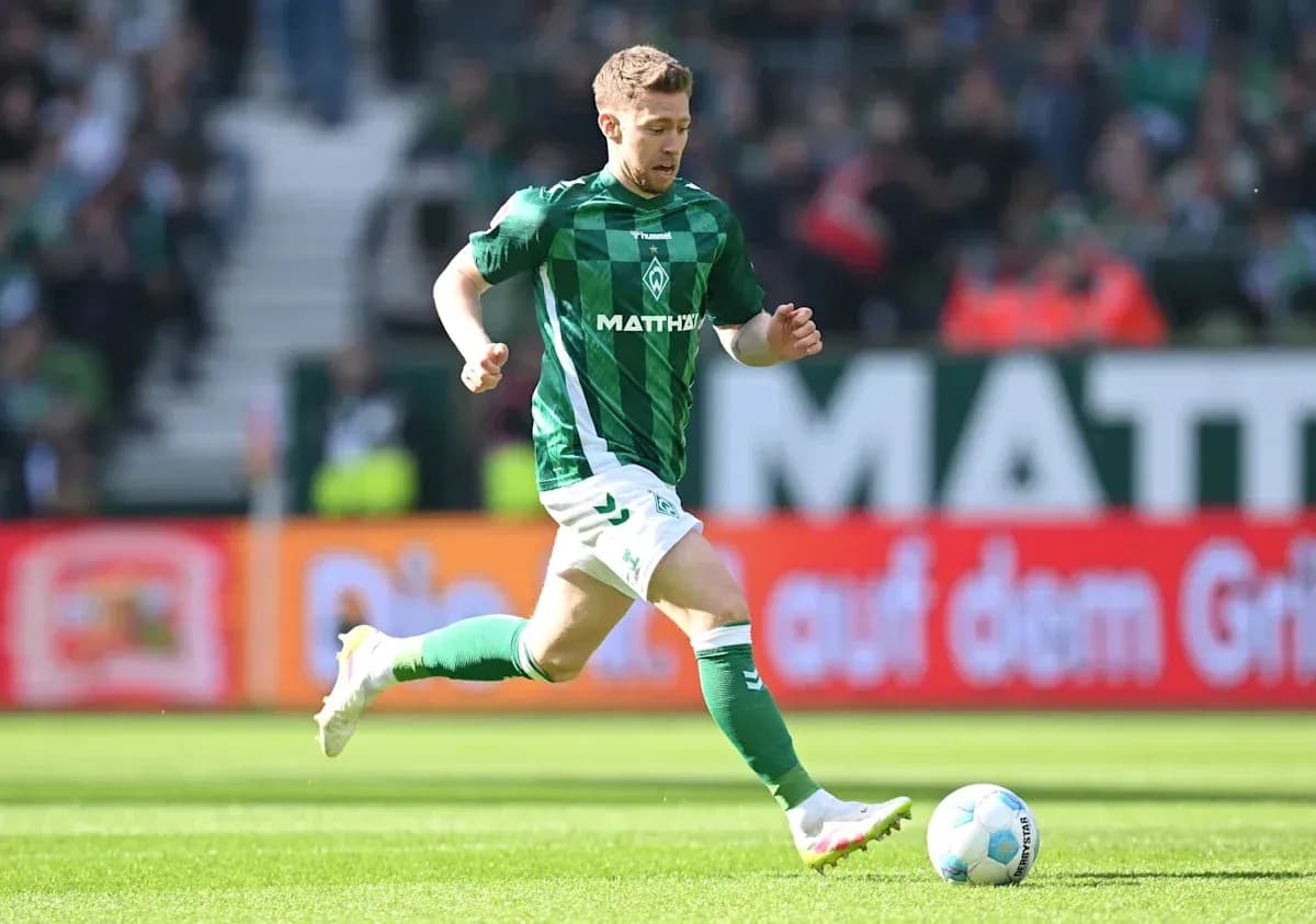 Player in green jersey running with the ball Player in green jersey running with the ball