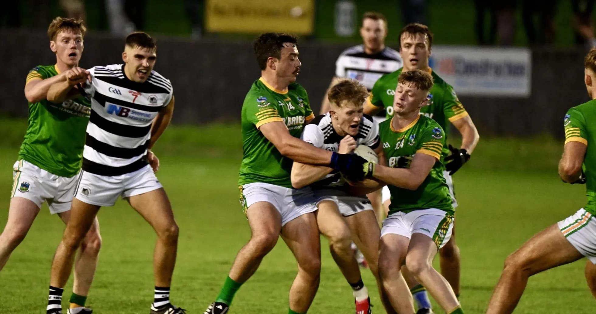 Players contesting possession during a Gaelic football match Players contesting possession during a Gaelic football match