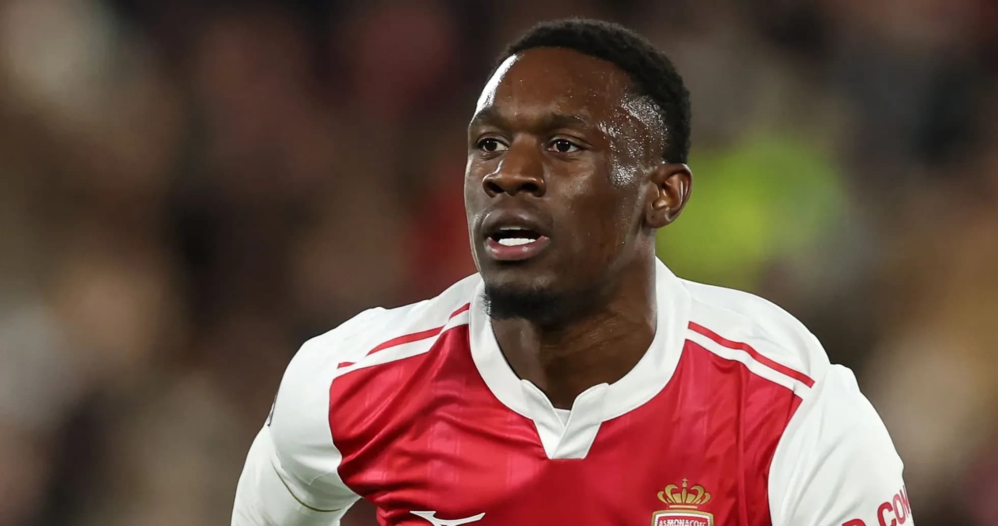 Player running during a football match wearing Monaco kit Player running during a football match wearing Monaco kit