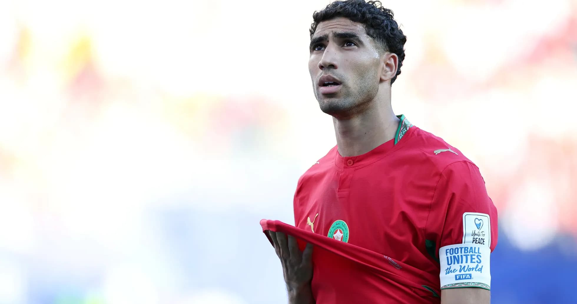 Player in red jersey adjusting shirt during match Player in red jersey adjusting shirt during match