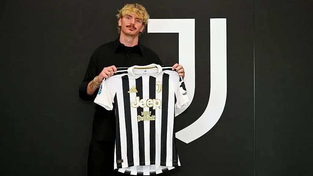 Player holding Juventus jersey at presentation event Player holding Juventus jersey at presentation event
