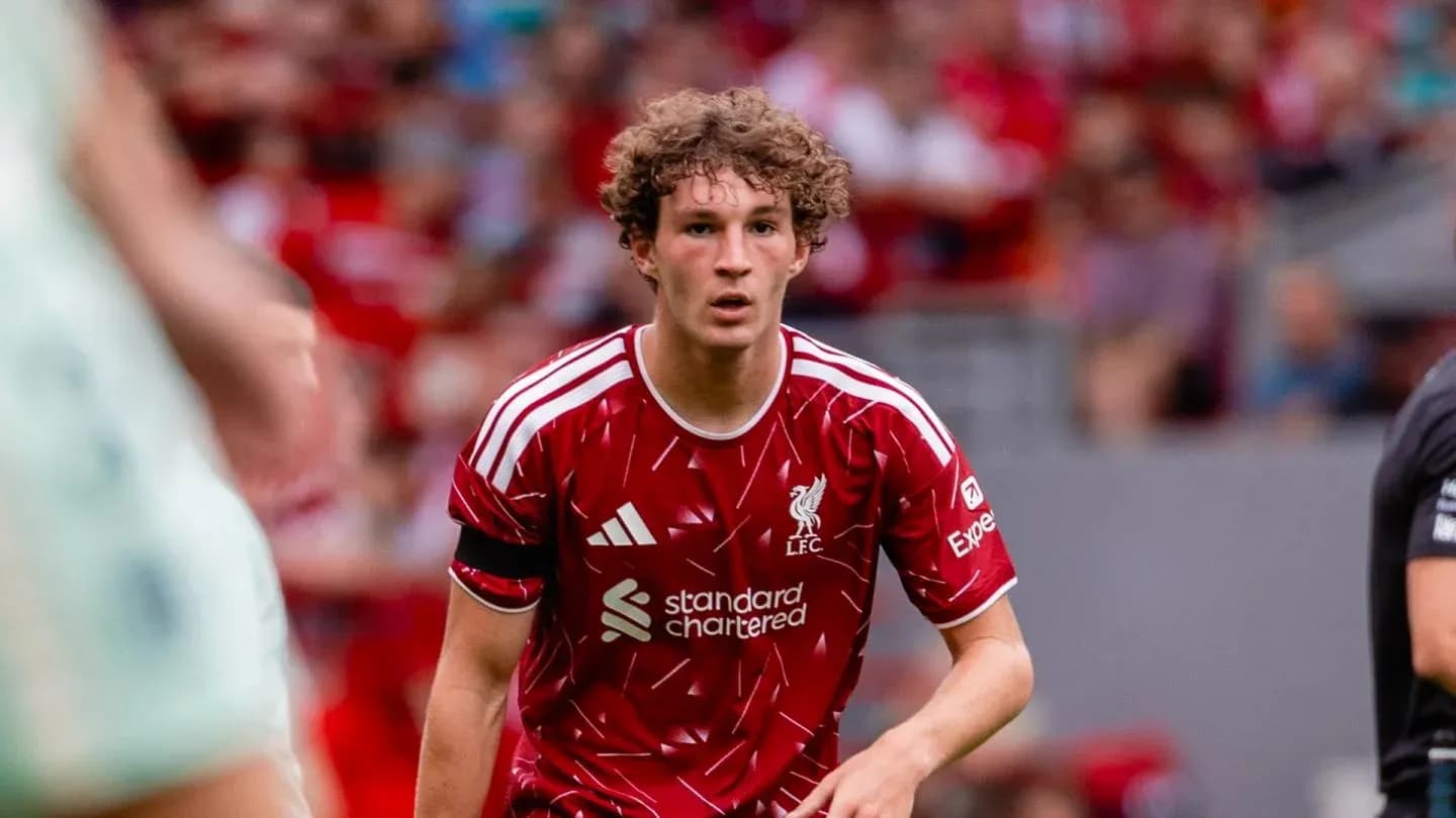 Player in red Liverpool kit on the pitch Player in red Liverpool kit on the pitch