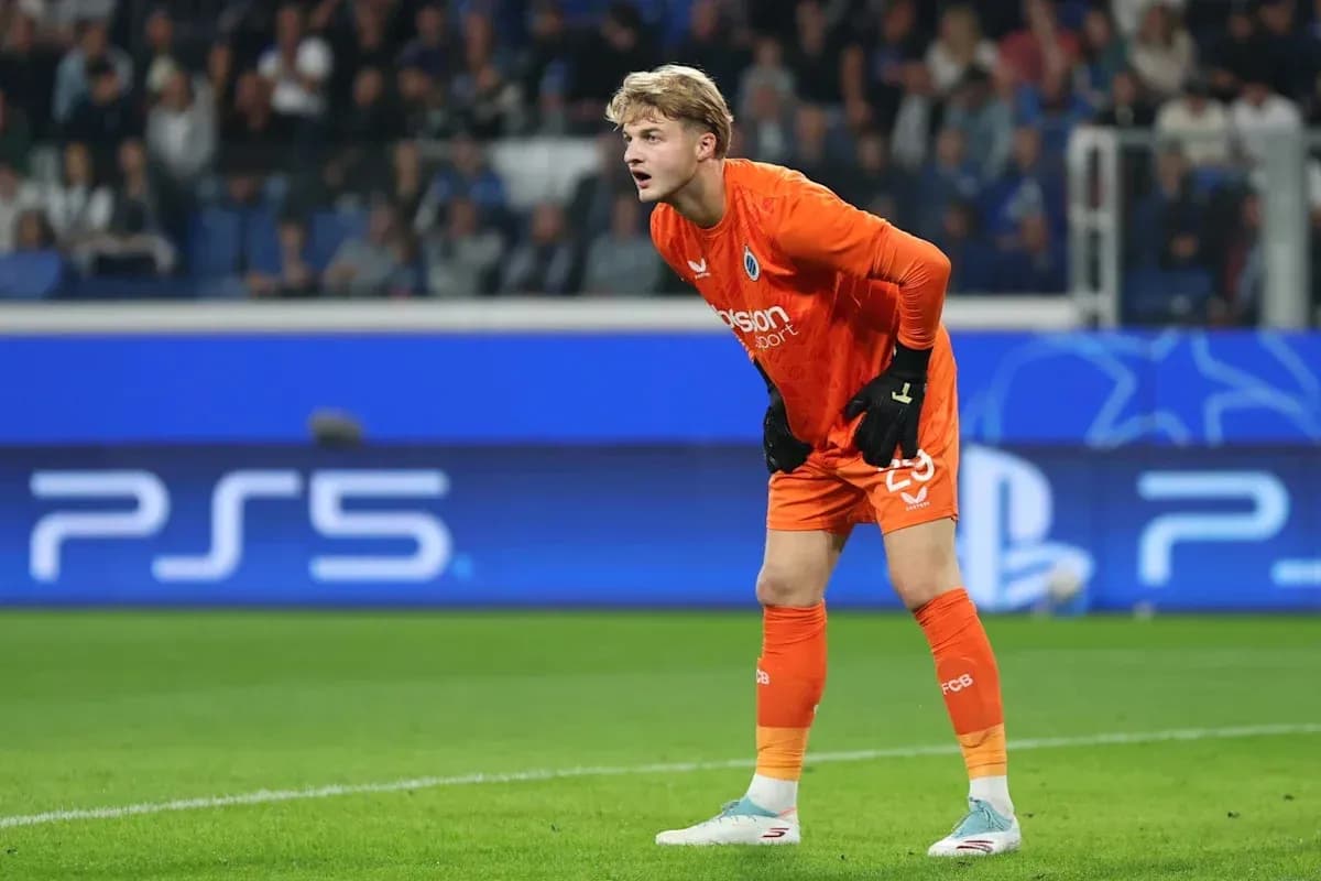 Goalkeeper in orange kit during match action Goalkeeper in orange kit during match action
