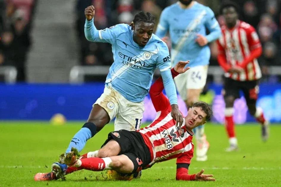 Player from Manchester City tackles Southampton player Player from Manchester City tackles Southampton player