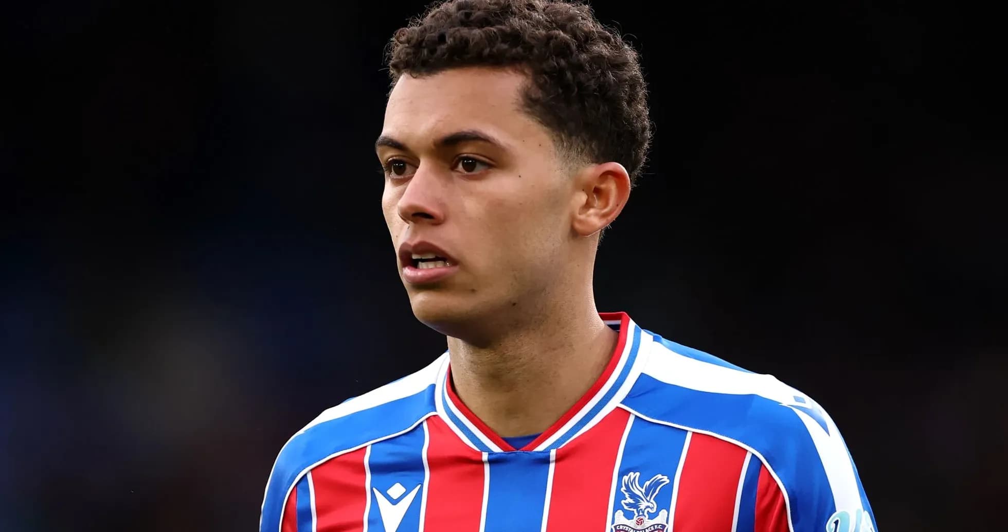 Player in Crystal Palace FC jersey on the field Player in Crystal Palace FC jersey on the field