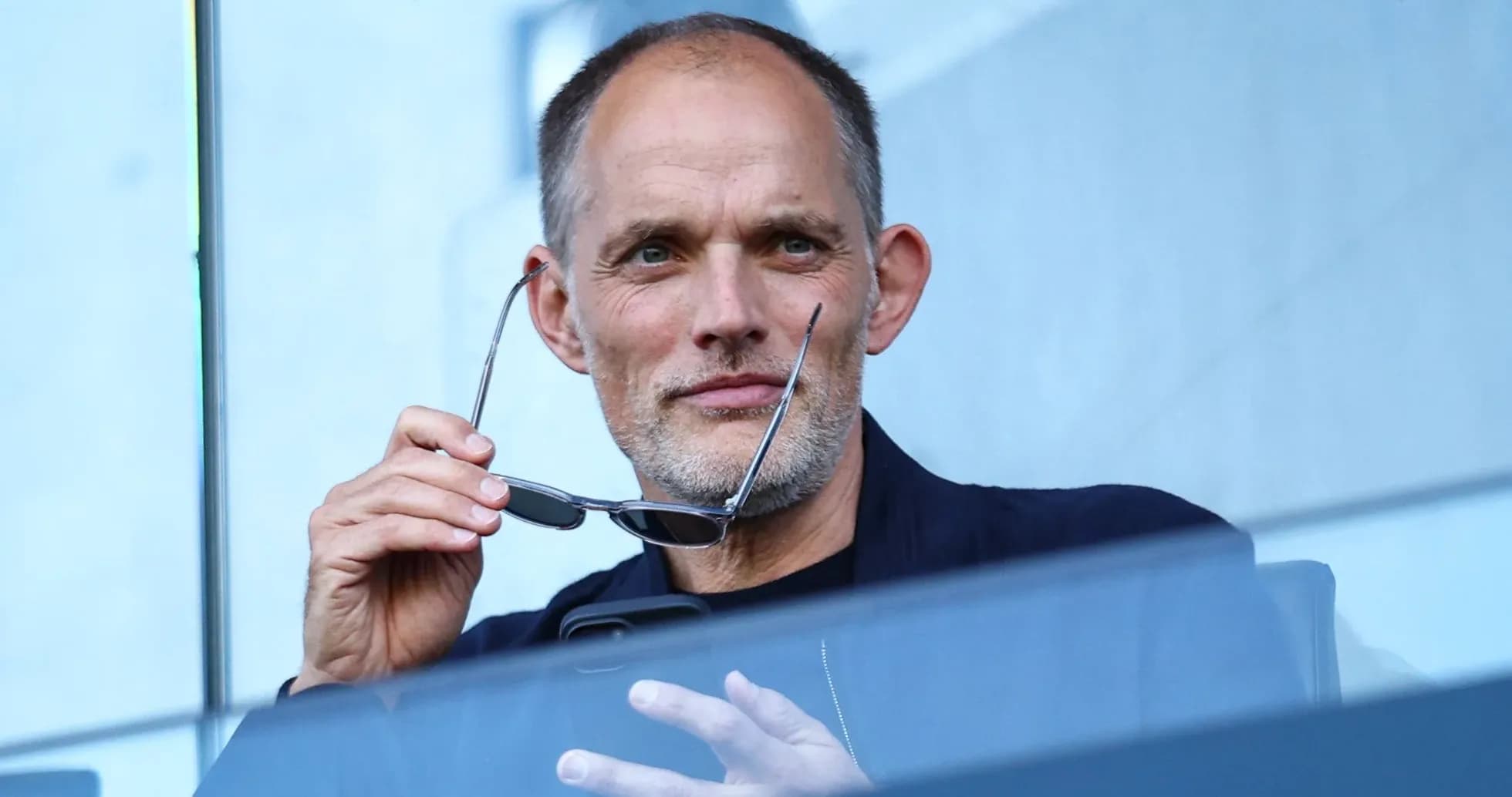 Man holding glasses while sitting in a stadium Man holding glasses while sitting in a stadium
