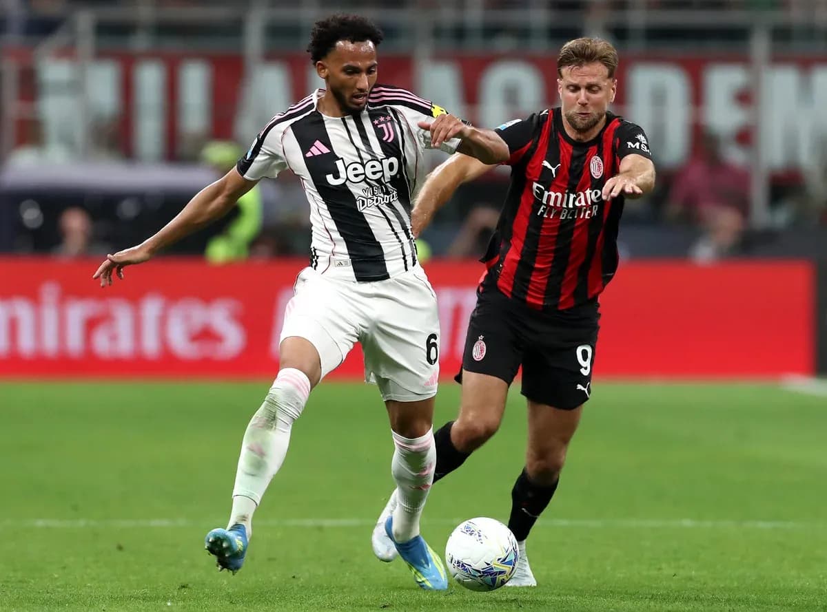 Juventus player competing against AC Milan player Juventus player competing against AC Milan player