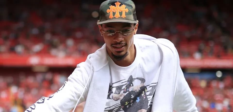 Player greeting fans in stadium before match Player greeting fans in stadium before match