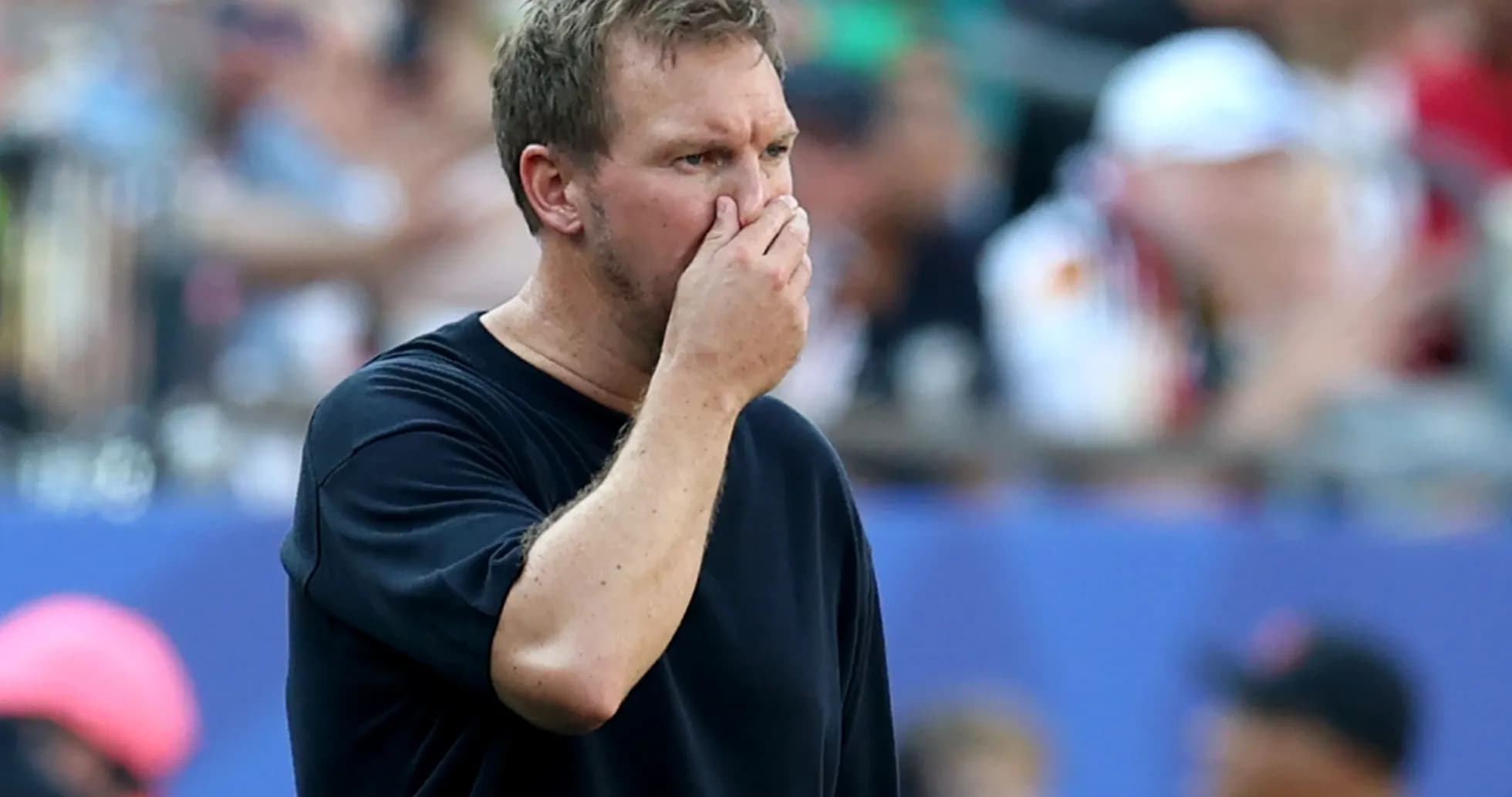 Coach observing game with hand on face Coach observing game with hand on face