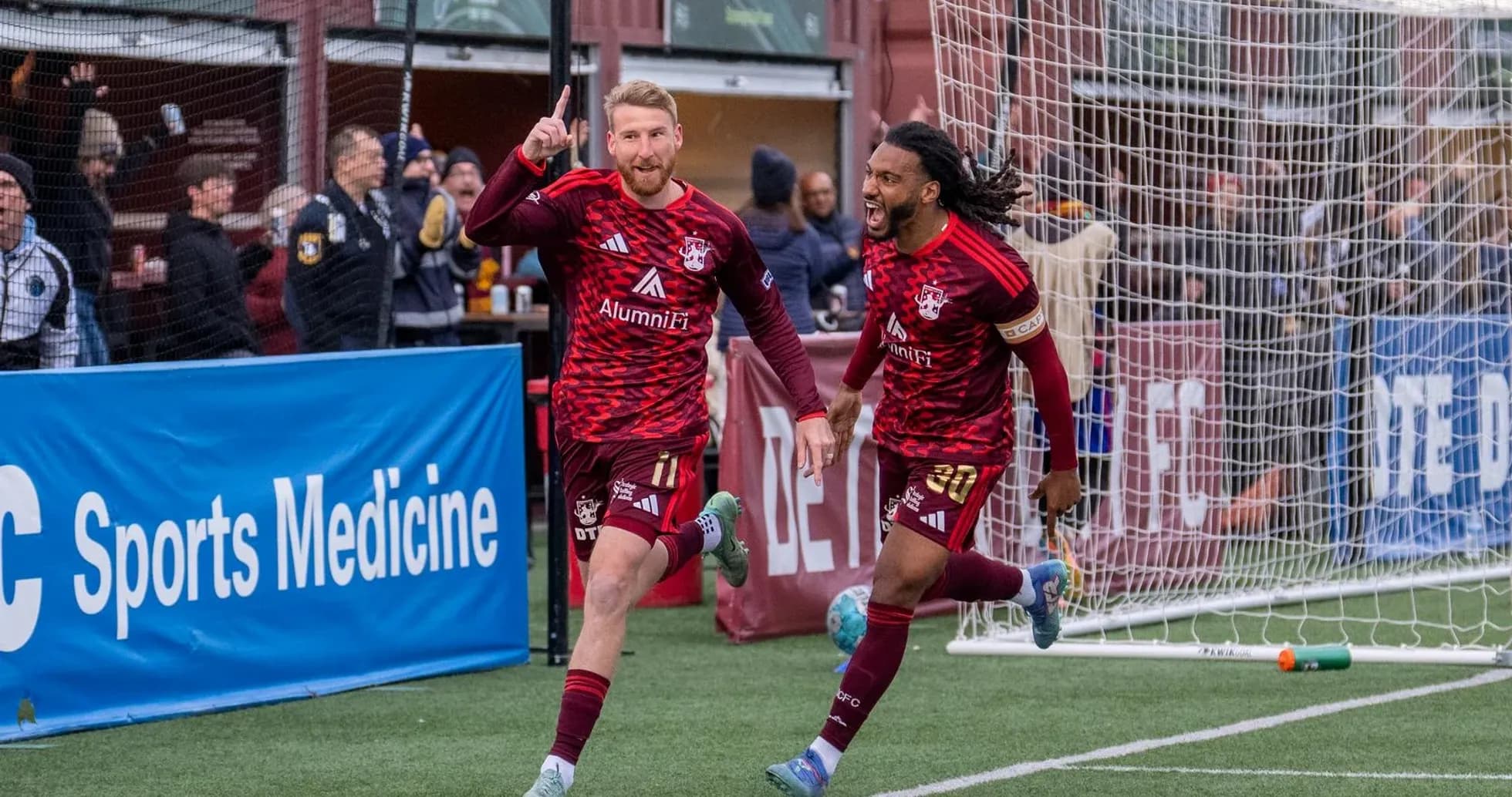 Players celebrating goal in Detroit City match Players celebrating goal in Detroit City match