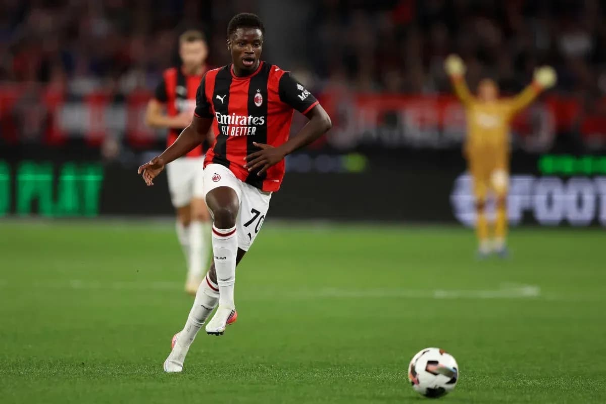 Player in AC Milan kit running with ball Player in AC Milan kit running with ball