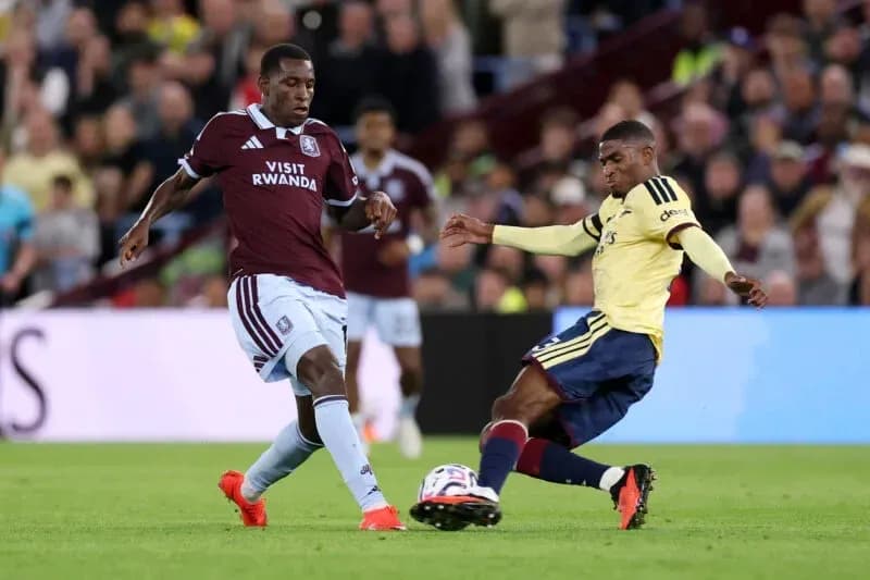 Players from Aston Villa and Arsenal contesting the ball Players from Aston Villa and Arsenal contesting the ball