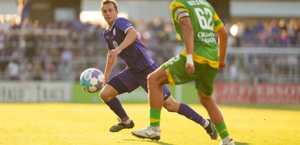 Player passing ball during Louisville City match Player passing ball during Louisville City match