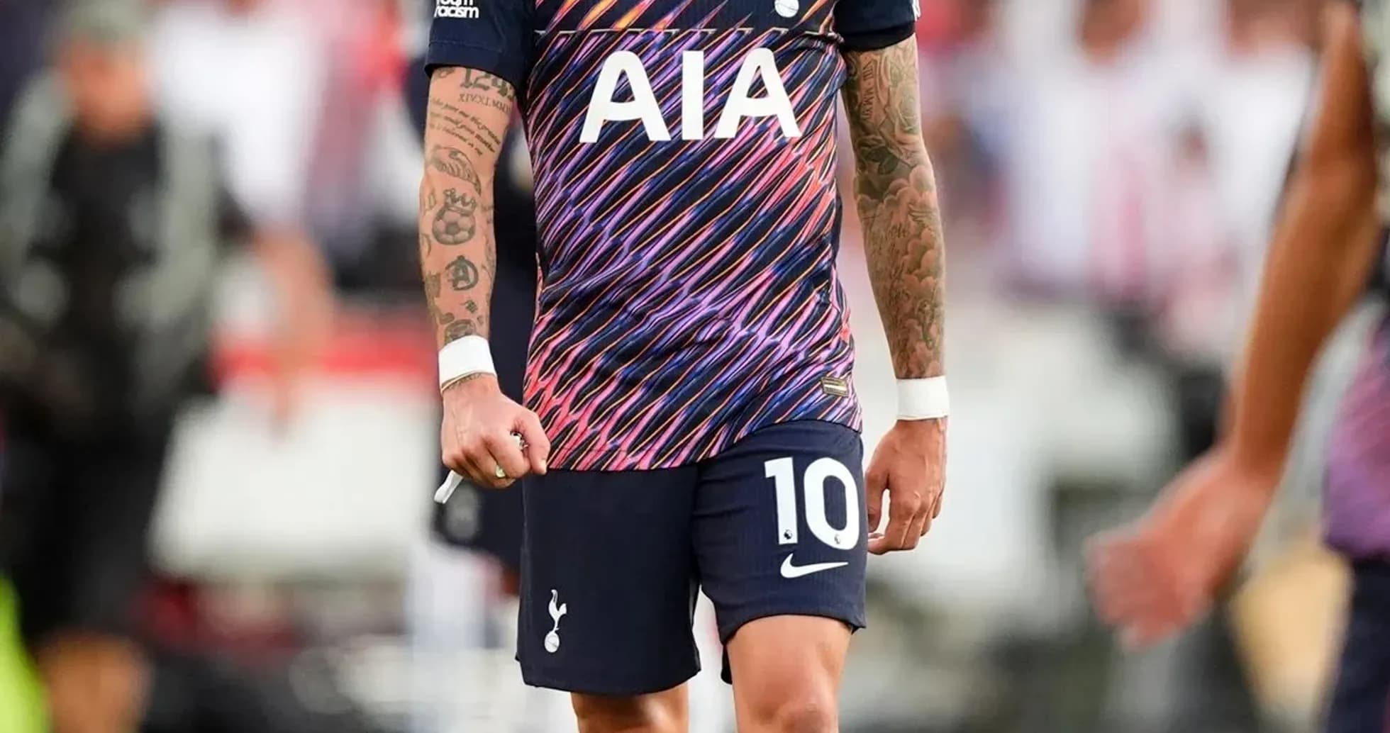Player in Tottenham jersey walking on the pitch Player in Tottenham jersey walking on the pitch
