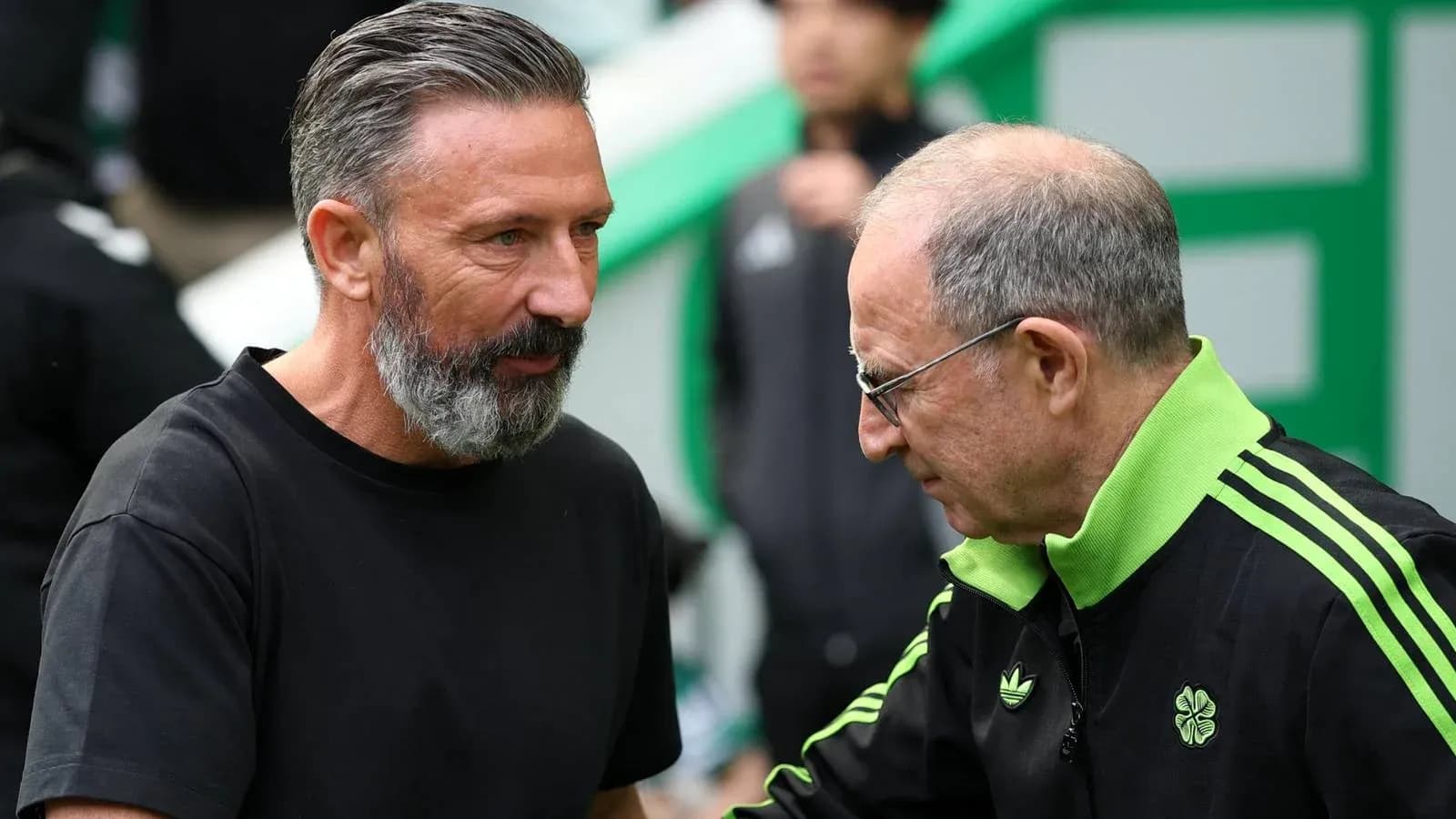 Two coaches engaging in conversation before match Two coaches engaging in conversation before match