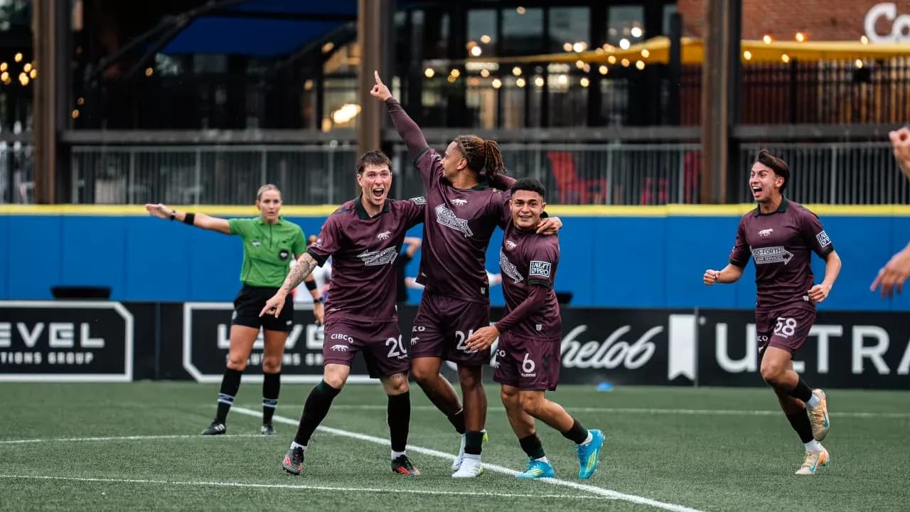 Players celebrating a goal during football match Players celebrating a goal during football match