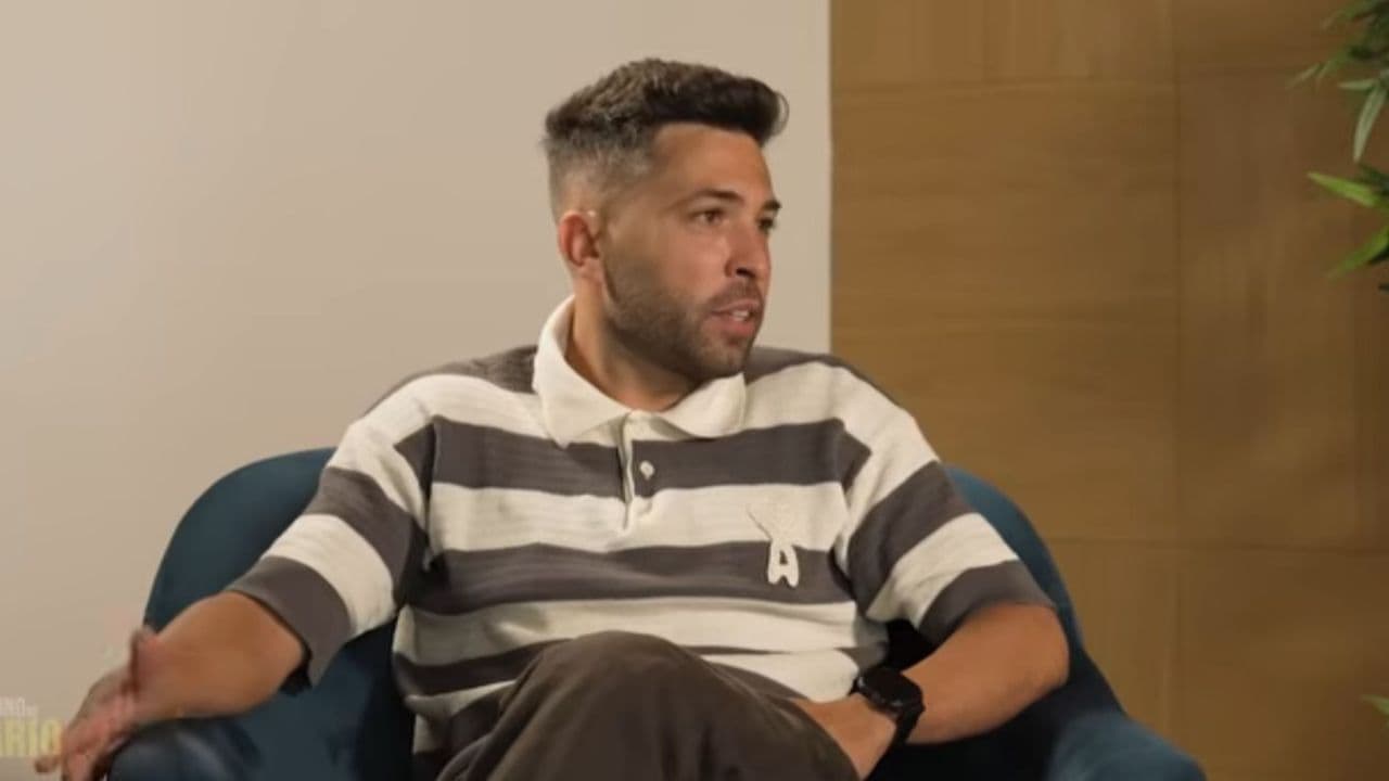 Man speaking while seated in a chair Man speaking while seated in a chair