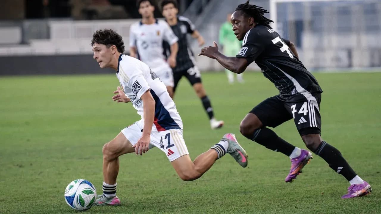 Player dribbling the ball during match action Player dribbling the ball during match action
