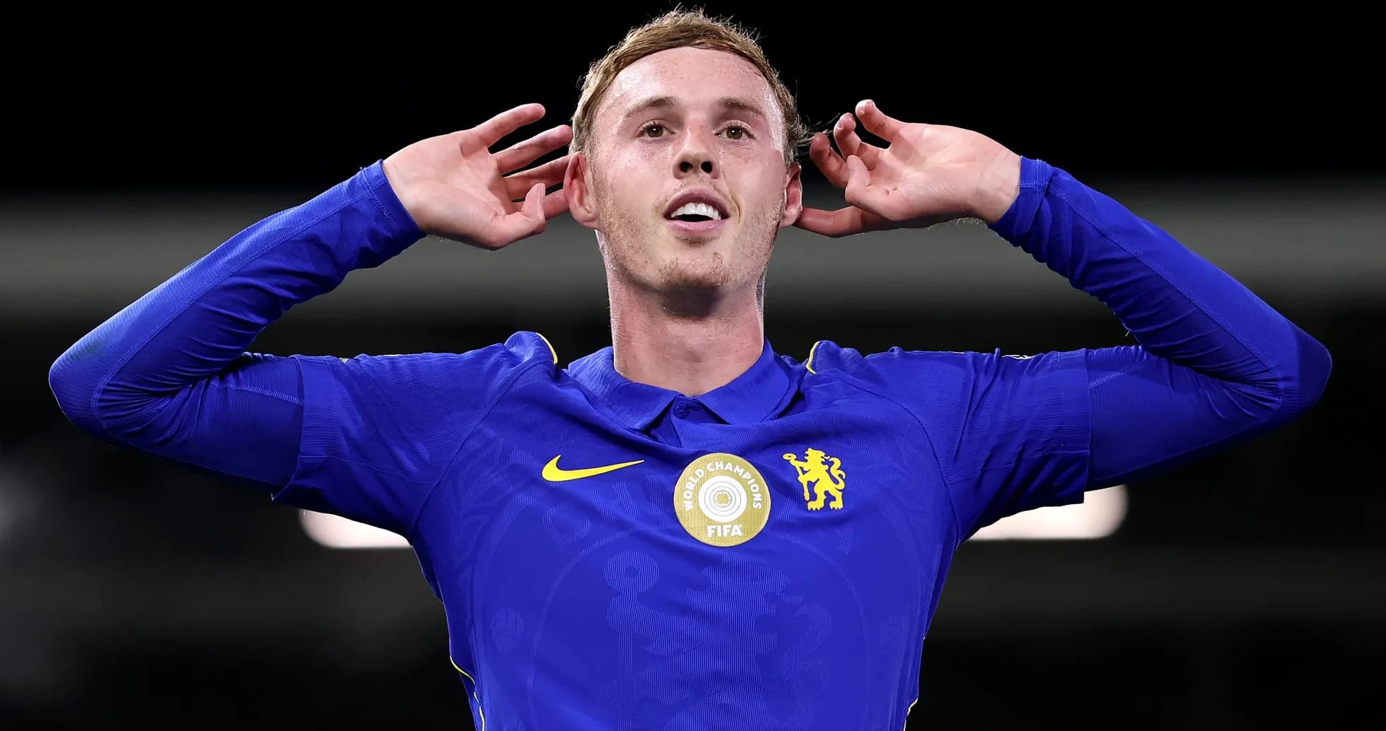 Player celebrating with hands on ears in blue kit Player celebrating with hands on ears in blue kit