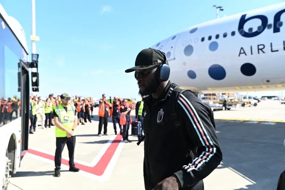 Player arriving at airport next to airplane Player arriving at airport next to airplane