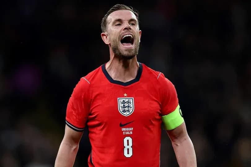 Player celebrating in England's red jersey with captain's armband Player celebrating in England's red jersey with captain's armband