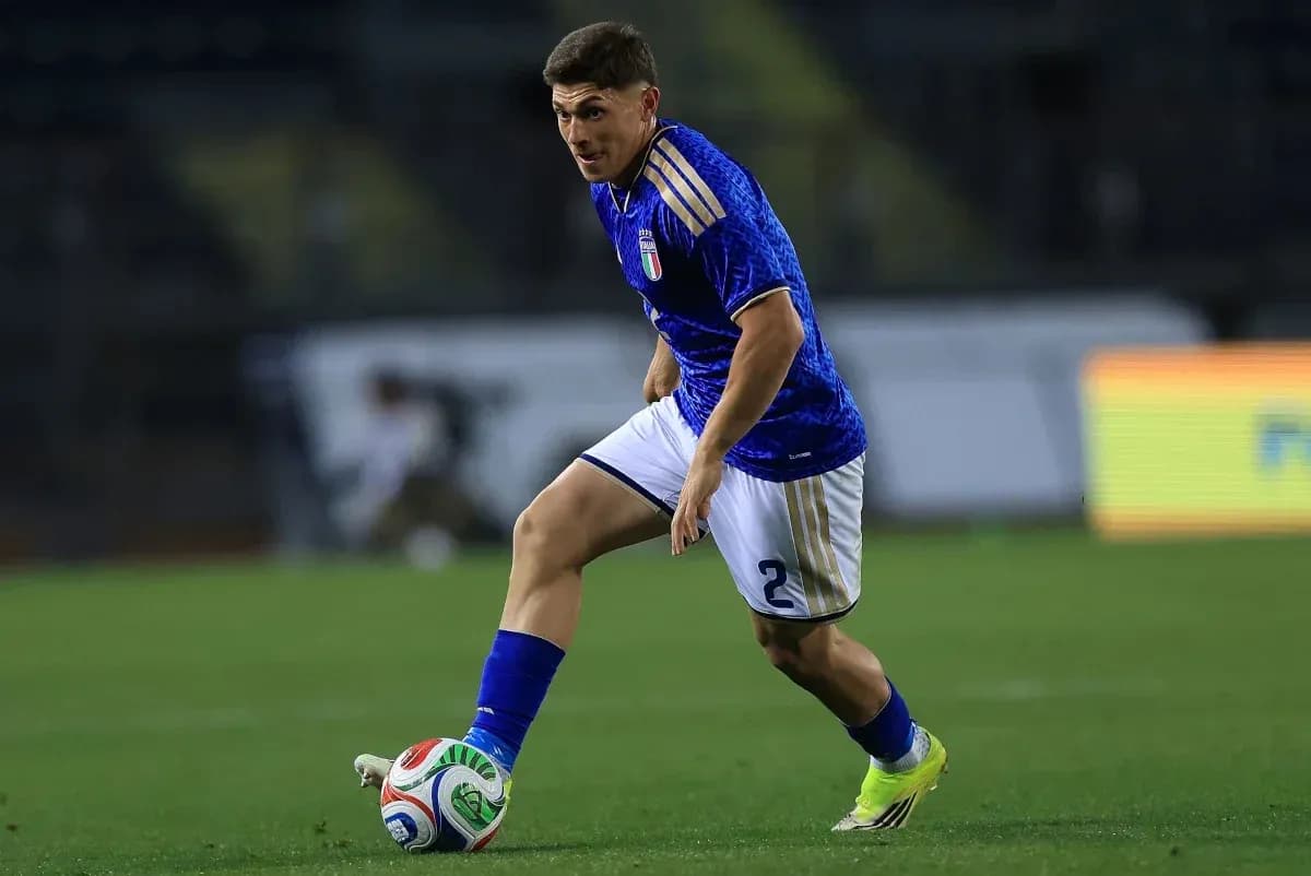 Player dribbling the ball during a football match Player dribbling the ball during a football match